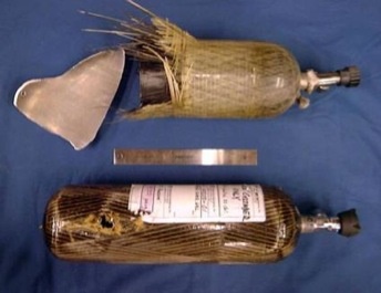 Side-by-side comparison of HEI's benign failure technology cylinder versus a conventional SCBA Type 3 cylinder showing catastrophic fragmentation failure